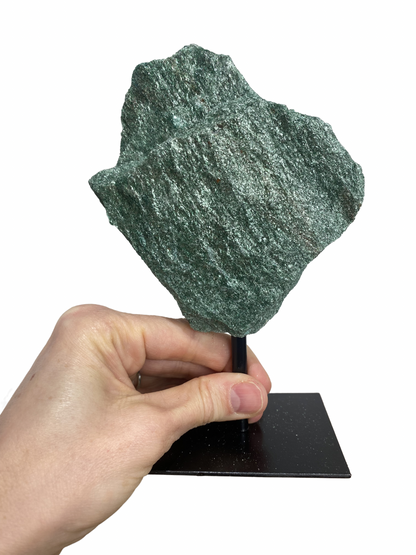 Raw Fuchsite sculpture on a stand
