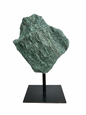 Raw Fuchsite sculpture on a stand