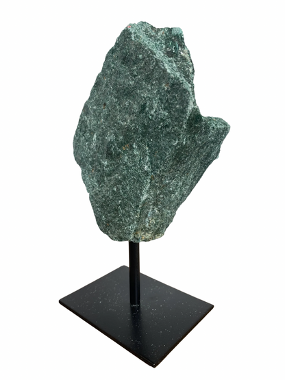 Raw Fuchsite sculpture on a stand