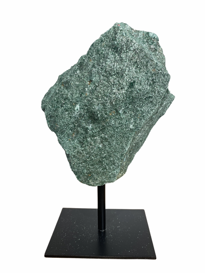 Raw Fuchsite sculpture on a stand