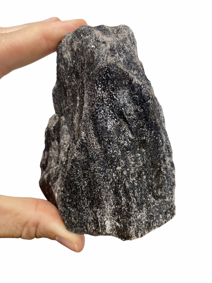 Raw Fuchsite sculpture on a stand